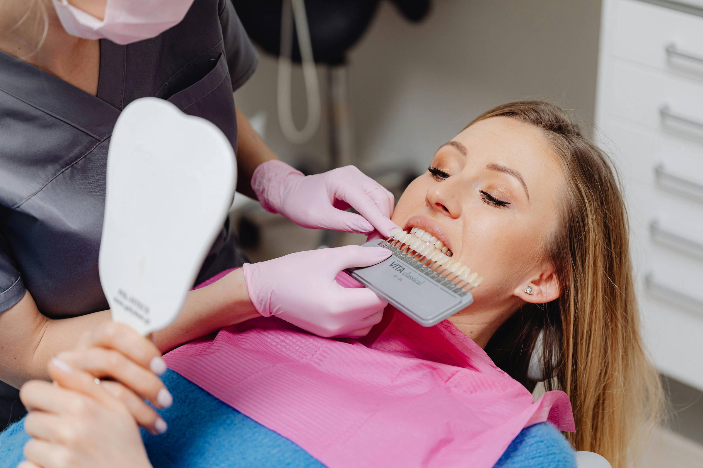 Woman in dental office getting veneers fitted.